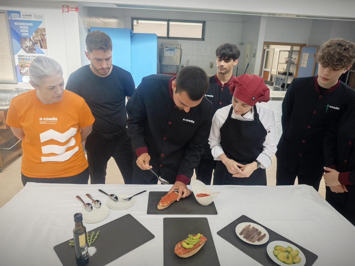 Alumnado de Cosda preparando tostadas con tomate.