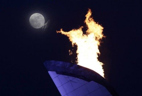 The moon rises behind the Olympic cauldron in Adler during the 2014 Sochi Winter Olympics