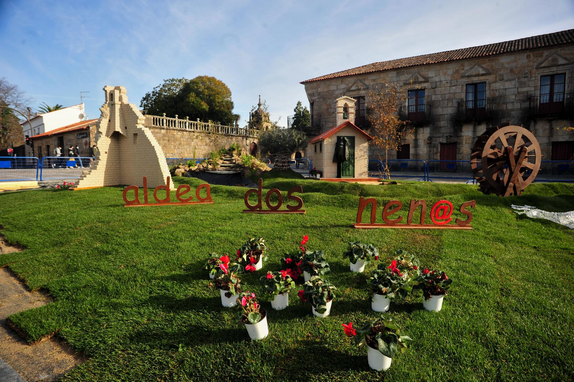 Los alumnos del Obradroiro de Emprego rematando la Aldea dos Nenos de Cambados