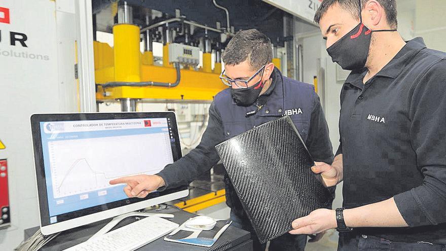 Técnicos de la empresa, con placas de carbono, el material del futuro medio de transporte revolucionario.