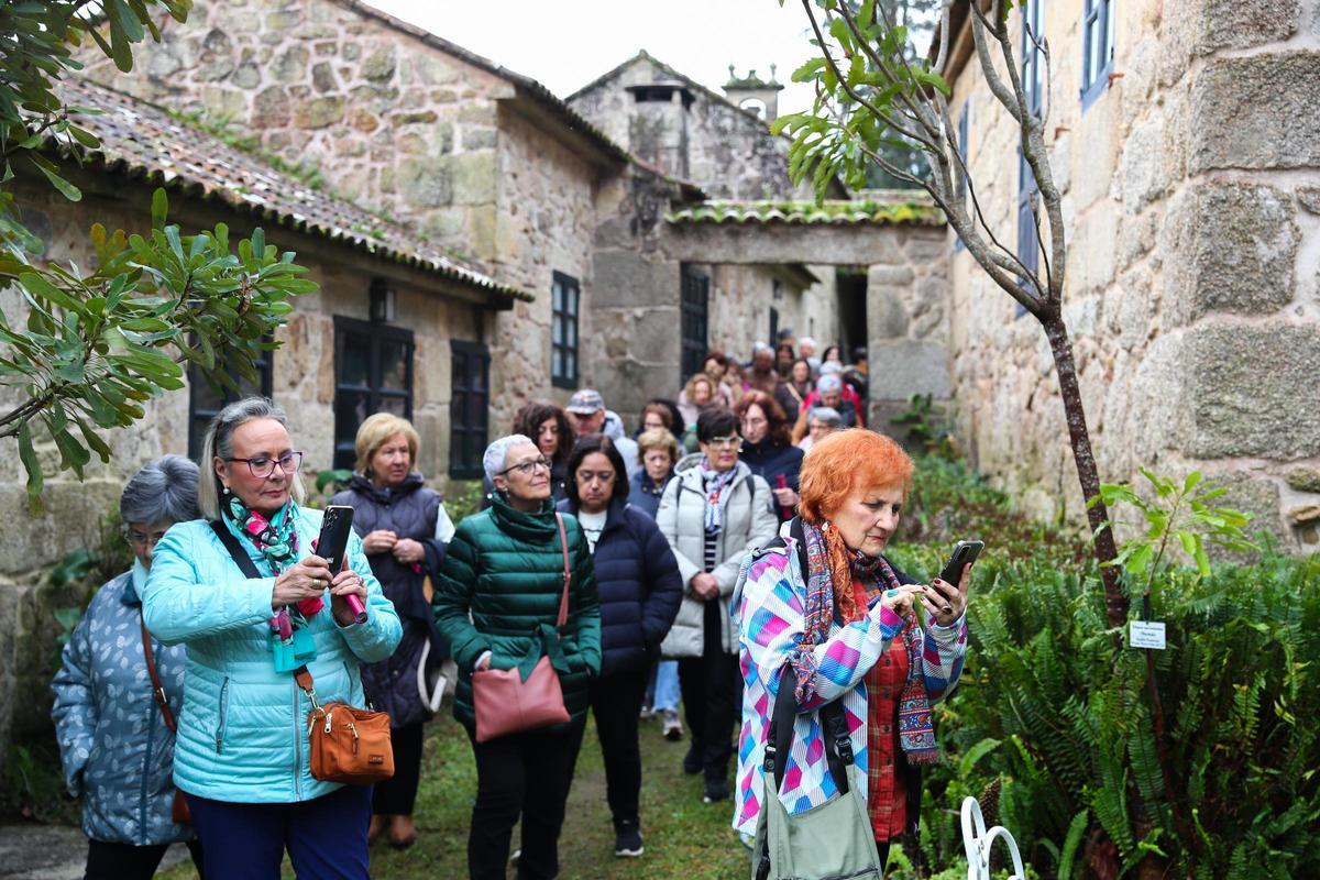El grupo pasea por uno de los corredores situados entre la casa y el jardín.