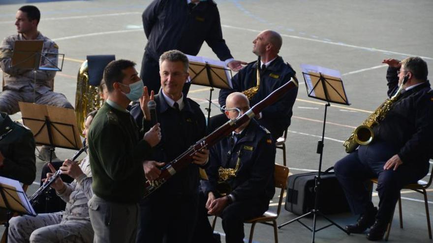 El director de la banda explica junto a uno de los músicos el instrumento del fagot.