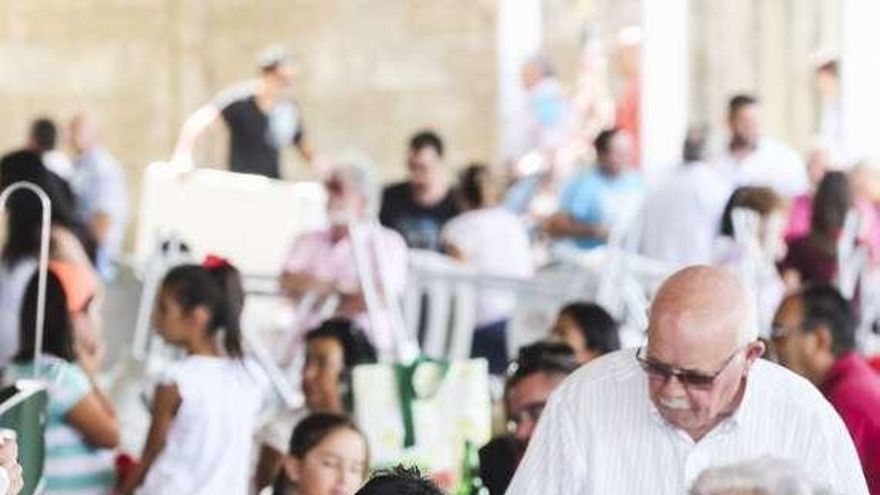 Varios asistentes a la fiesta del Cristo de Colloto, ayer, en la carpa.