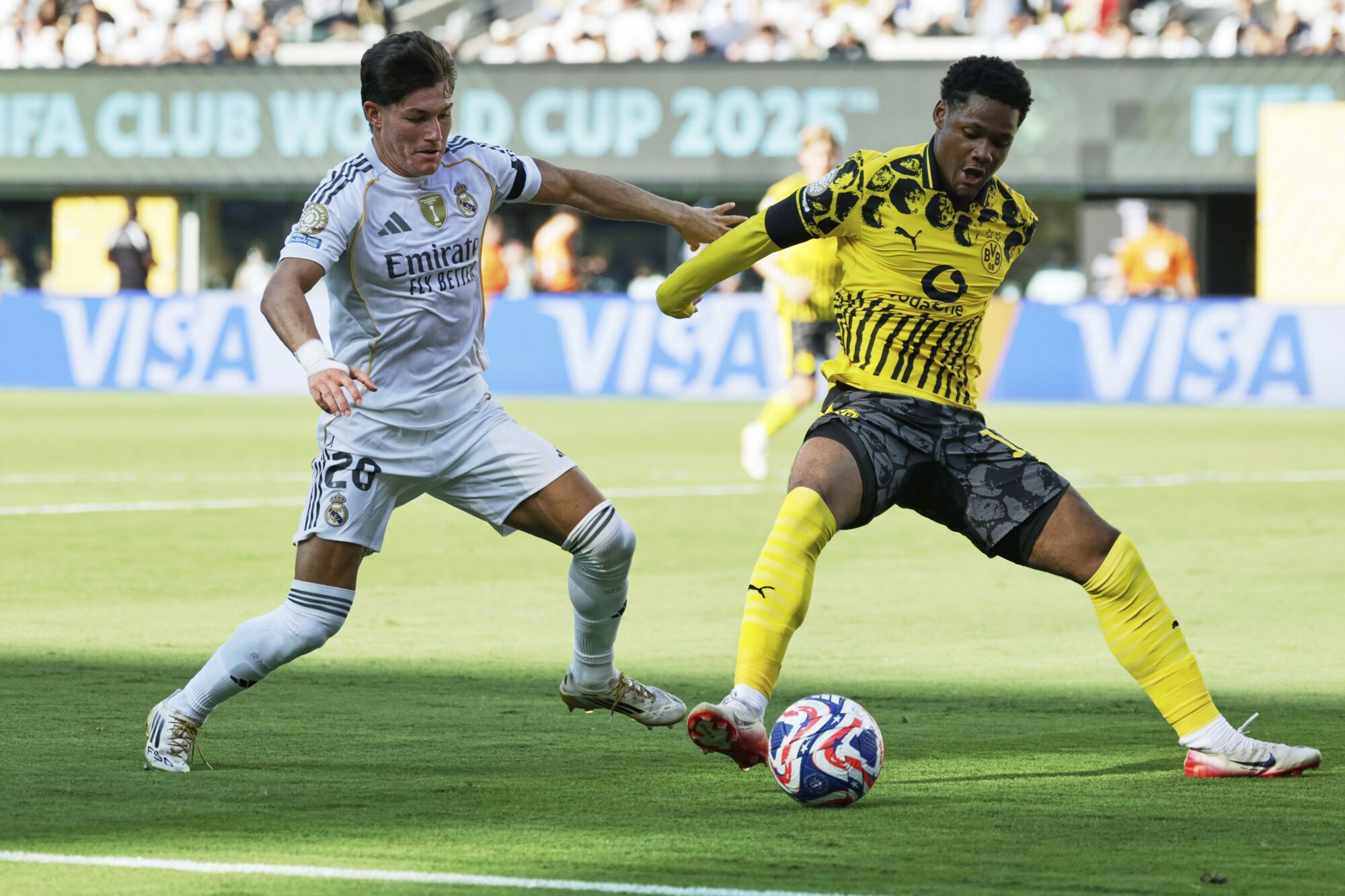 Borussia Dortmund's Julien Duranville, right, and Real Madrid's Fran Garcia battle for the ball during the Club World Cup quarterfinal soccer match between Real Madrid and Borussia Dortmund in East Rutherford, N.J., Saturday, July 5, 2025. (AP Photo/Adam Hunger)