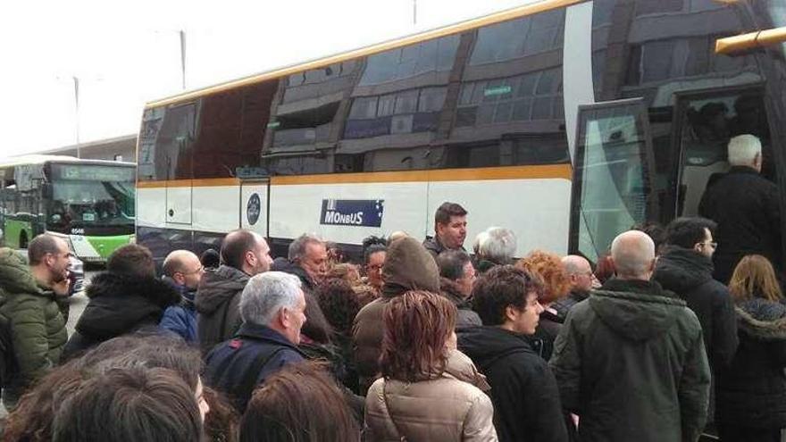 Pasajeros que se quedaron el martes sin barco en Vigo suben a un autobús a O Morrazo. // FGS.