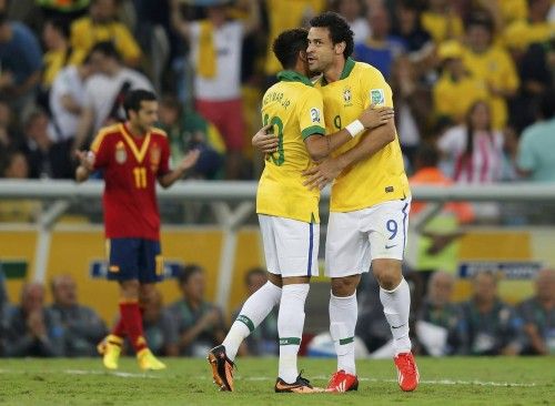 Brazil's Fred celebrates with teammate Neymar after scoring a goal against Spain during the Confederations Cup final soccer match in Rio de Janeiro