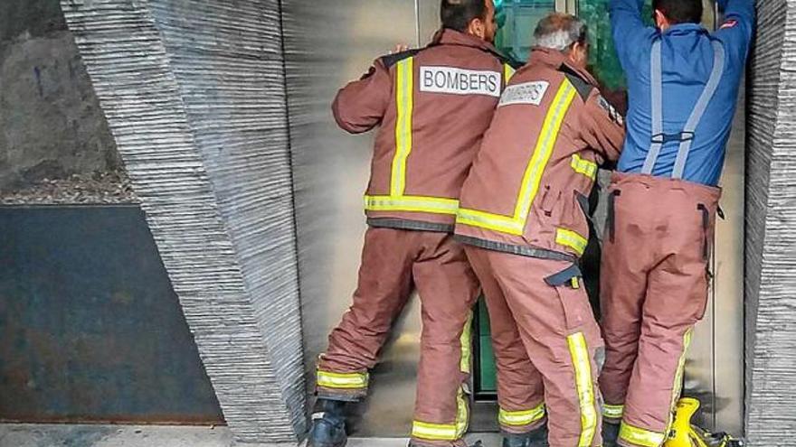 Bombers de Puigcerdà mirant d&#039;obrir l&#039;ascensor avariat