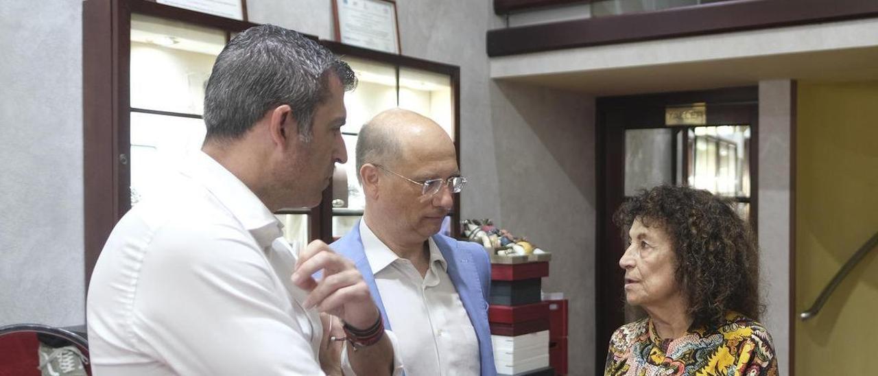 Manuel Domínguez y Carlos Bethencourtm charlan con Encarna Estéve, dueña de la joyería Encarnita en Triana.