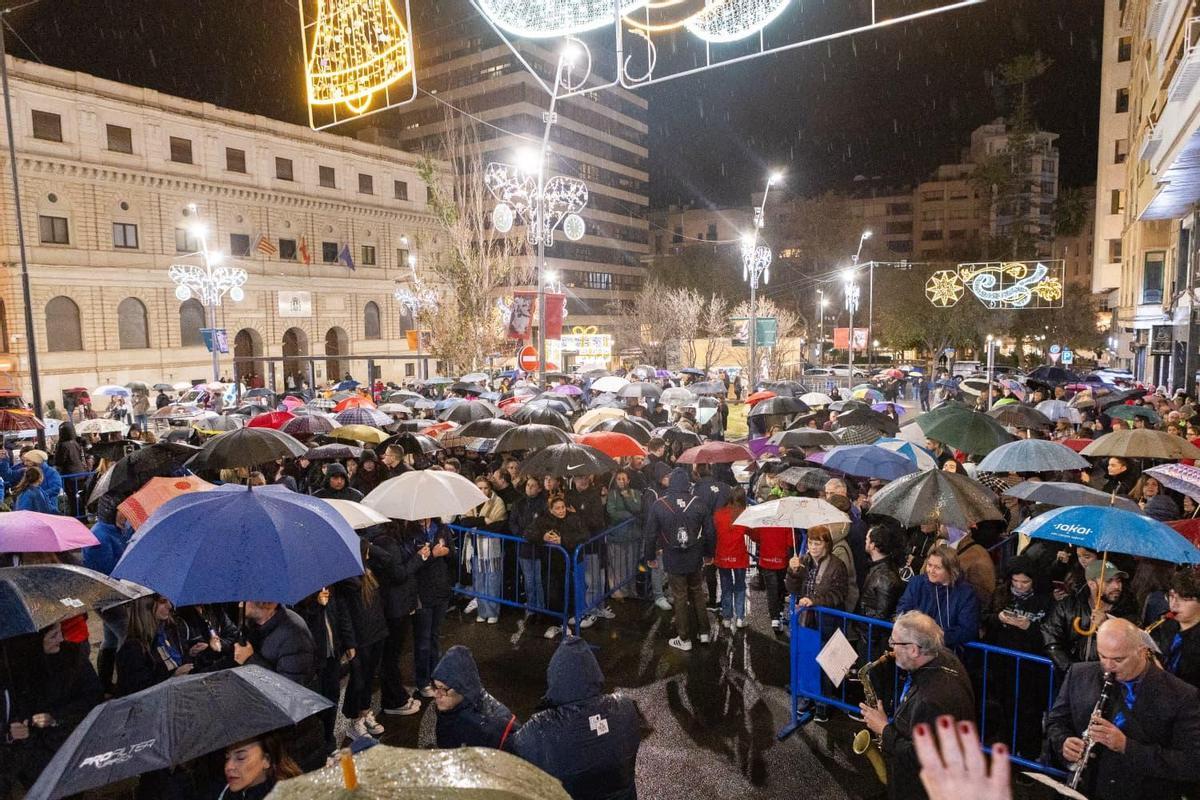 Paraguas en mano nadie se ha querido perder la cremà de la hoguera de Navidad.