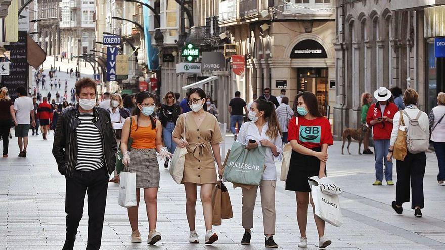 Imagen de archivo de gente paseando por el centro de Vigo con mascarilla.