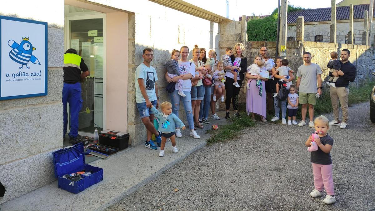 Familias con sus hijos esperando a que desbloquean las cerraduras de A Galiña Azul de Moaña.