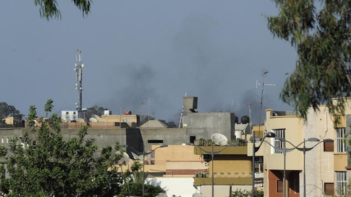 Smoke rises from the skyline in Tripoli