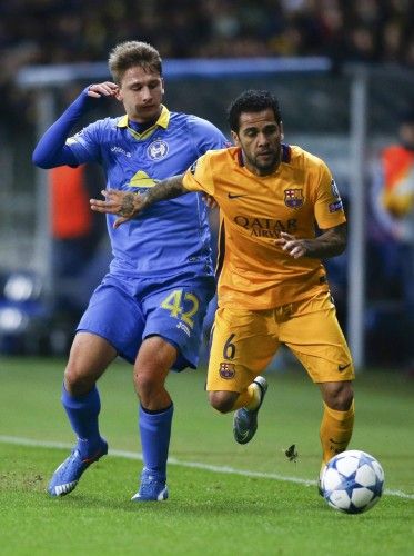 Barcelona's Alves fights for ball with BATE Borisov's Volodko during their Champions League group E soccer match at Borisov Arena stadium outside Minsk
