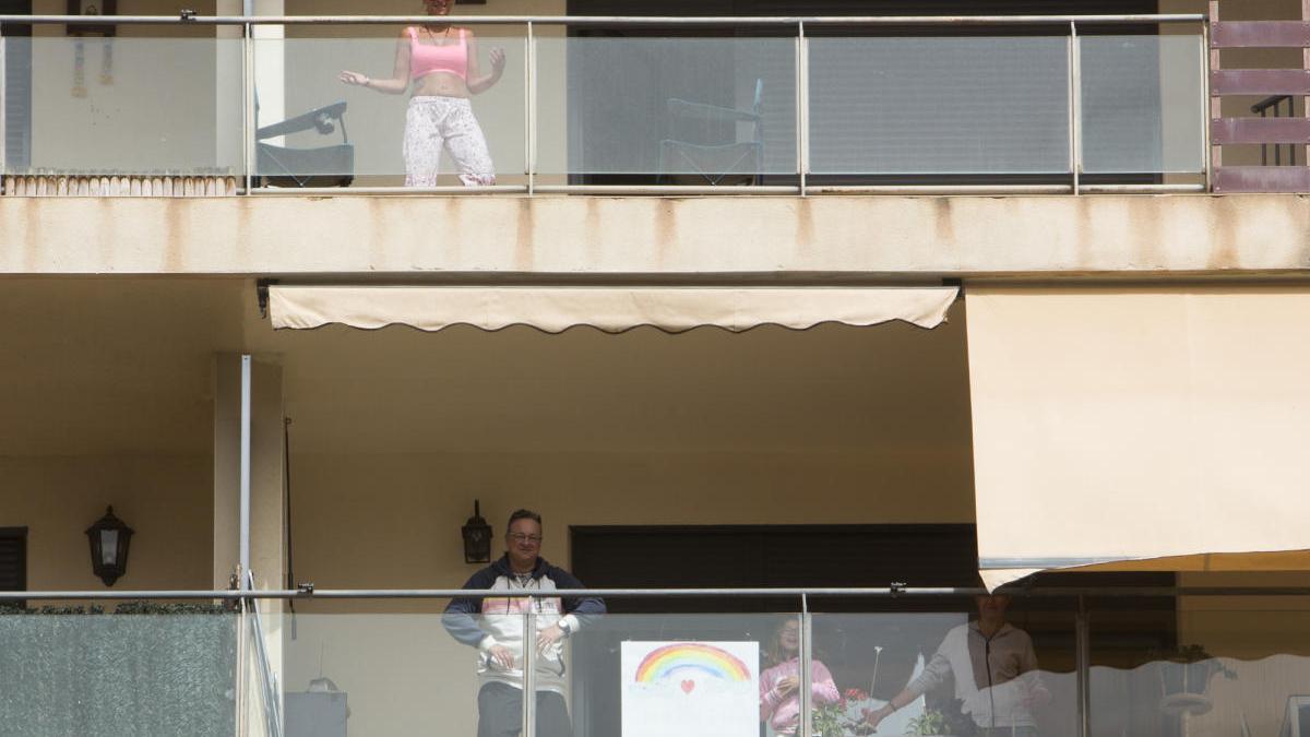 Vecinos de una urbanización de Alicante hacen gimnasia en sus terrazas