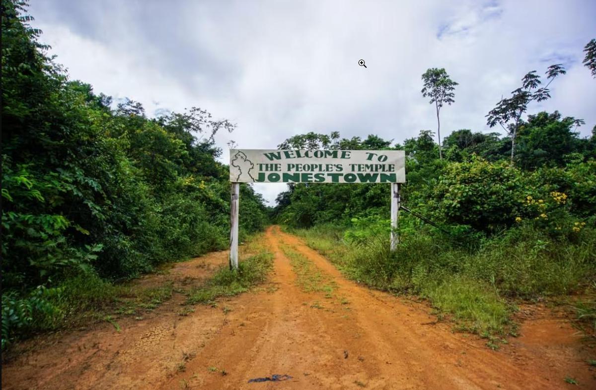 Entrada a Jonestown con el letrero: "Bienvenido al Templo del Pueblo"