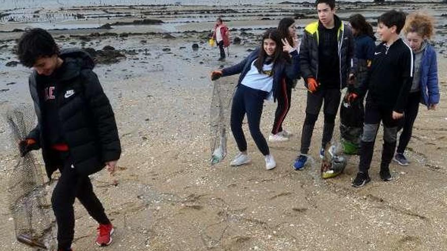 Eliminación de residuos en la playa de A Compostela, ayer. // N. Parga