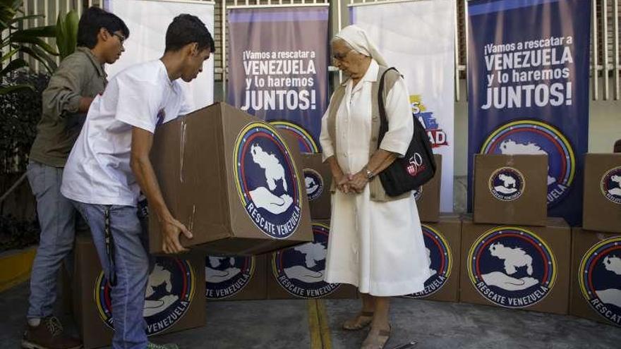 Voluntarios cargan medicinas en Caracas. // Efe