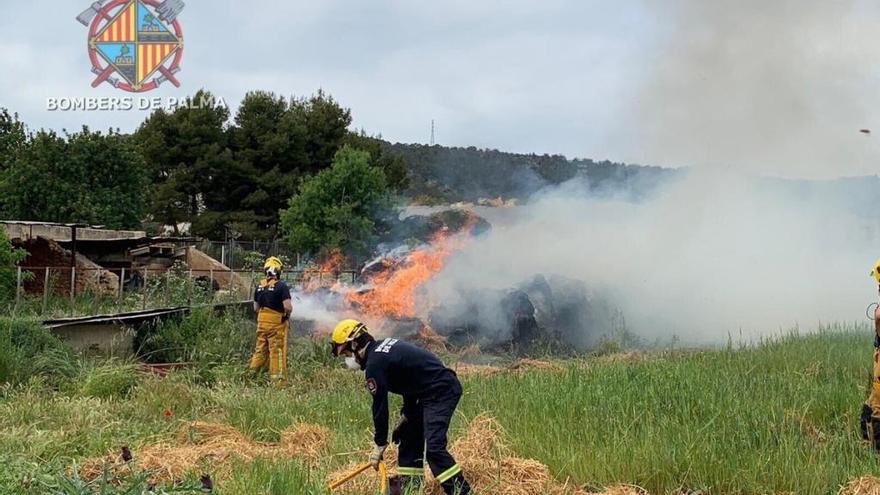 Bomberos se encargan de sofocar el fuego de balas de paja en un descampado de Can Valero.