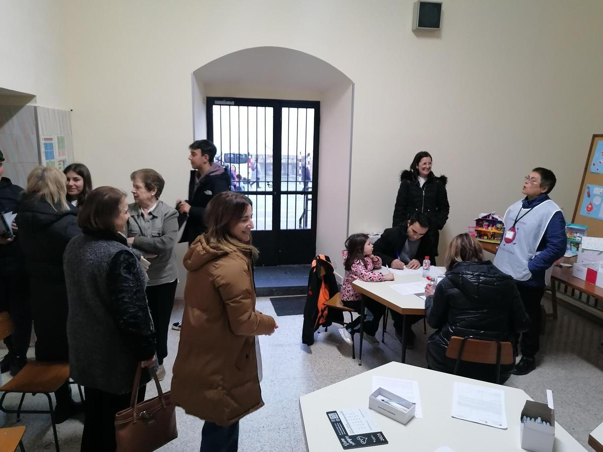 Varias personas esperan para donar sangre en el colegio