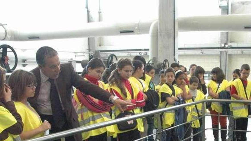 Marcelino Coto, edil de Porriño, muestra la depuradora de Guillarei  a un grupo de niños del municipio porriñés.  // D. P.