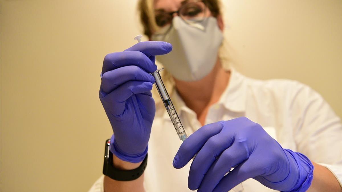 A Johnson   Johnson worker prepares a syringe during the Phase 3 ENSEMBLE trial of its Janssen coronavirus disease (COVID-19) vaccine candidate in an undated photograph  Johnson   Johnson Handout via REUTERS  ATTENTION EDITORS - NO RESALES  NO ARCHIVES  THIS IMAGE HAS BEEN SUPPLIED BY A THIRD PARTY