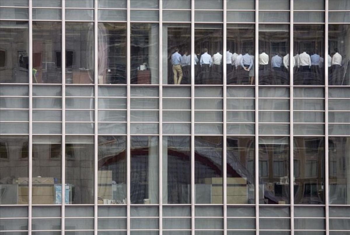 Staff members stand in a meeting room at Lehman Brothers offices in the financial district of Canary Wharf in London in this September 11, 2008.