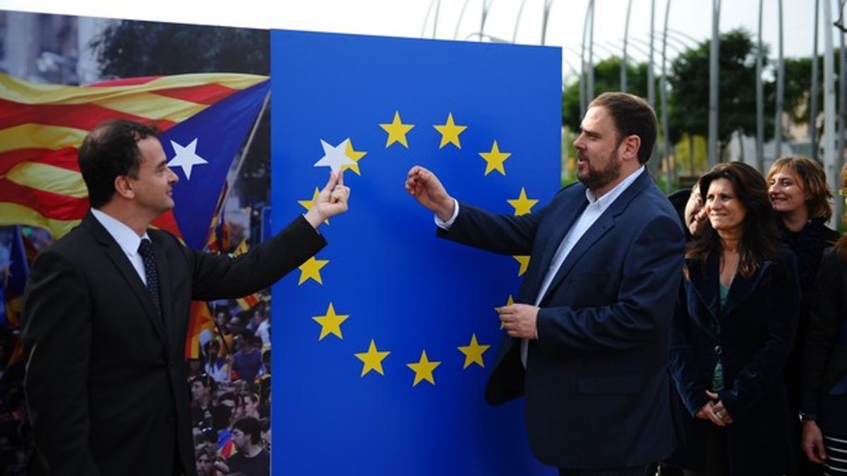 El candidato de ERC, Oriol Junqueras, coloca la supuesta futura estrella del Estado catalán junto al resto de las de la Unión Europea, este jueves, en Barcelona. JORDI COTRINA