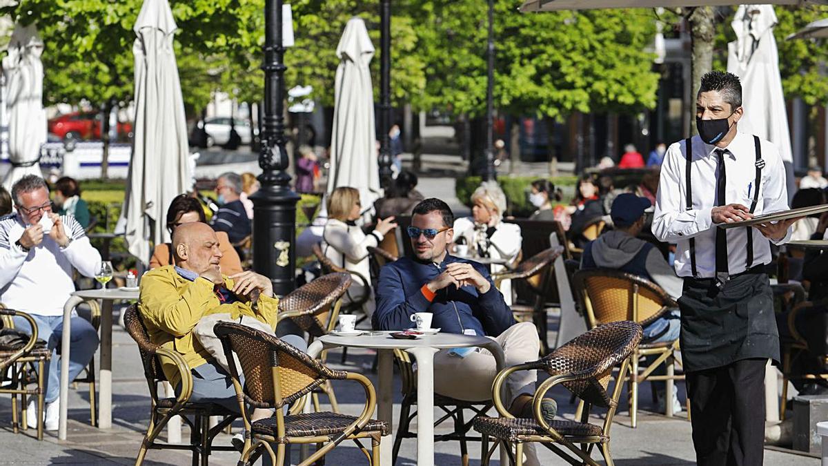 El día soleado hizo que ayer costara encontrar un sitio en las terrazas de muchas localidades de la región. En la imagen, ambiente en el paseo de Begoña de Gijón. | Marcos León