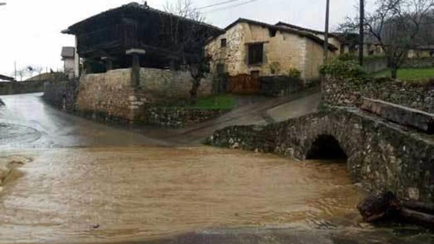 El agua invade una carretera en Avín (Onís)