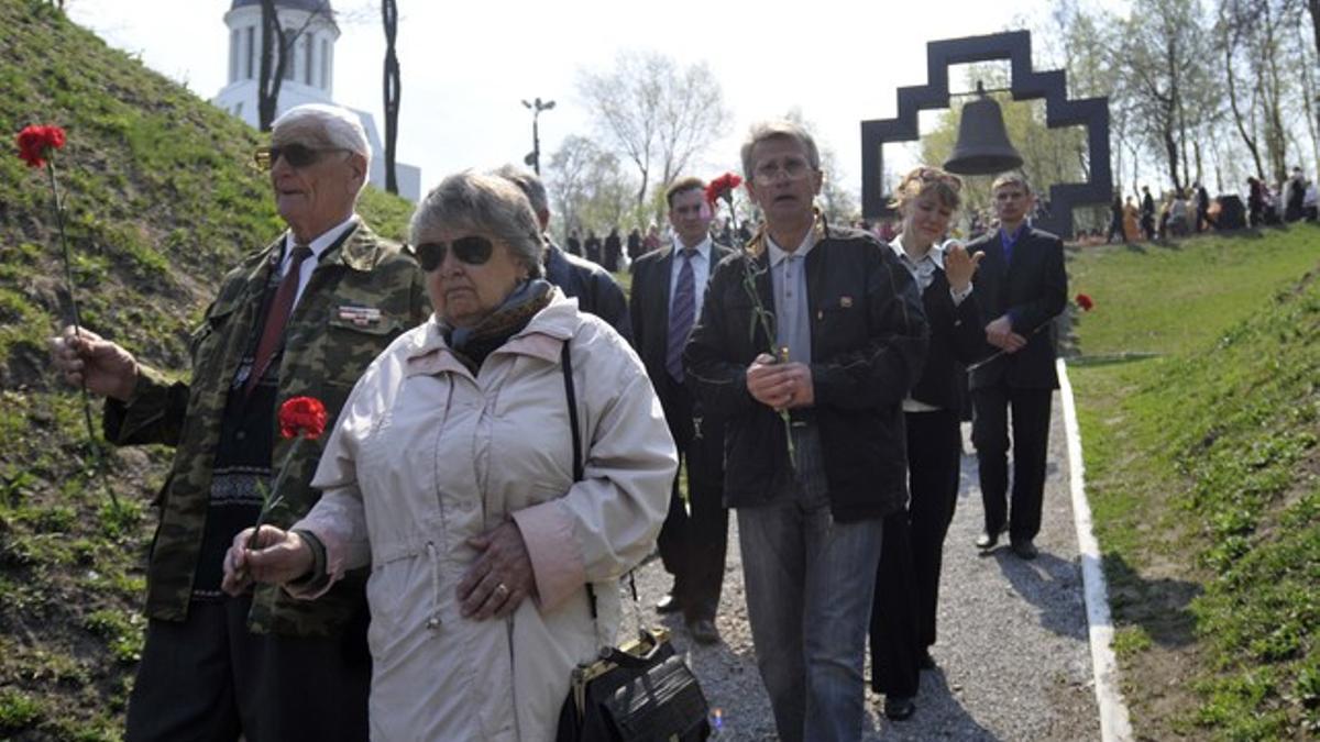 Ciudadanos ucranianos se dirigen a la ceremonia en memoria de las víctimas de Chernóbil, este martes, en Kiev.