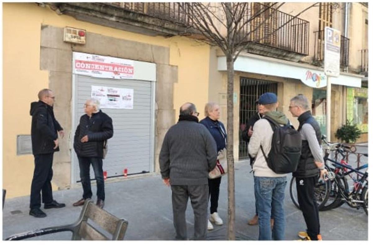 Diverses persones davant del bar Los Faroles de la Bisbal, aques matí.