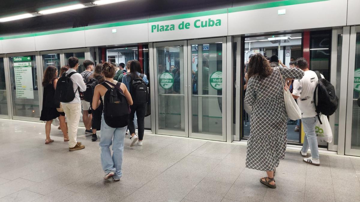 Saturación de viajeros que intentan acceder a un vagón del Metro de Sevilla en Plaza de Cuba, ya lleno de gente