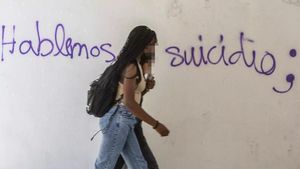 Una joven frente a una pintada sobre la prevención del suicidio.
