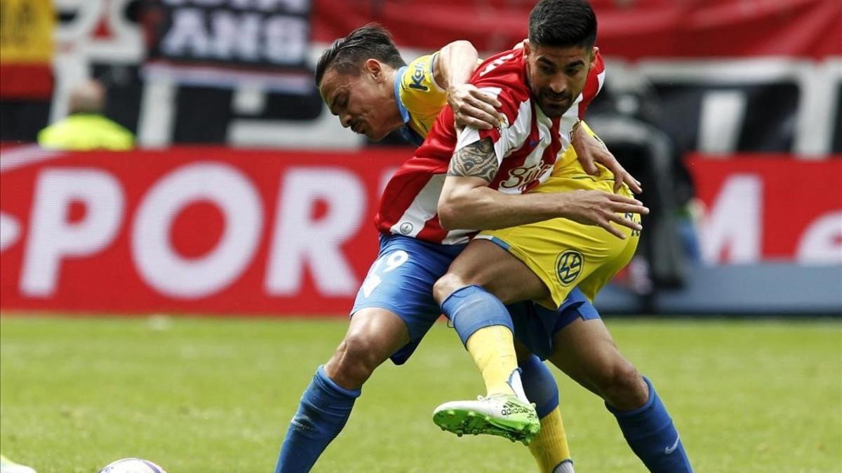 Carmona, del Sporting, y Roque Mesa, del Las Palmas, durante un partido de Liga.