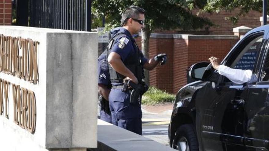 Un policía pide la identificación a un coche en la sede de la Marina.