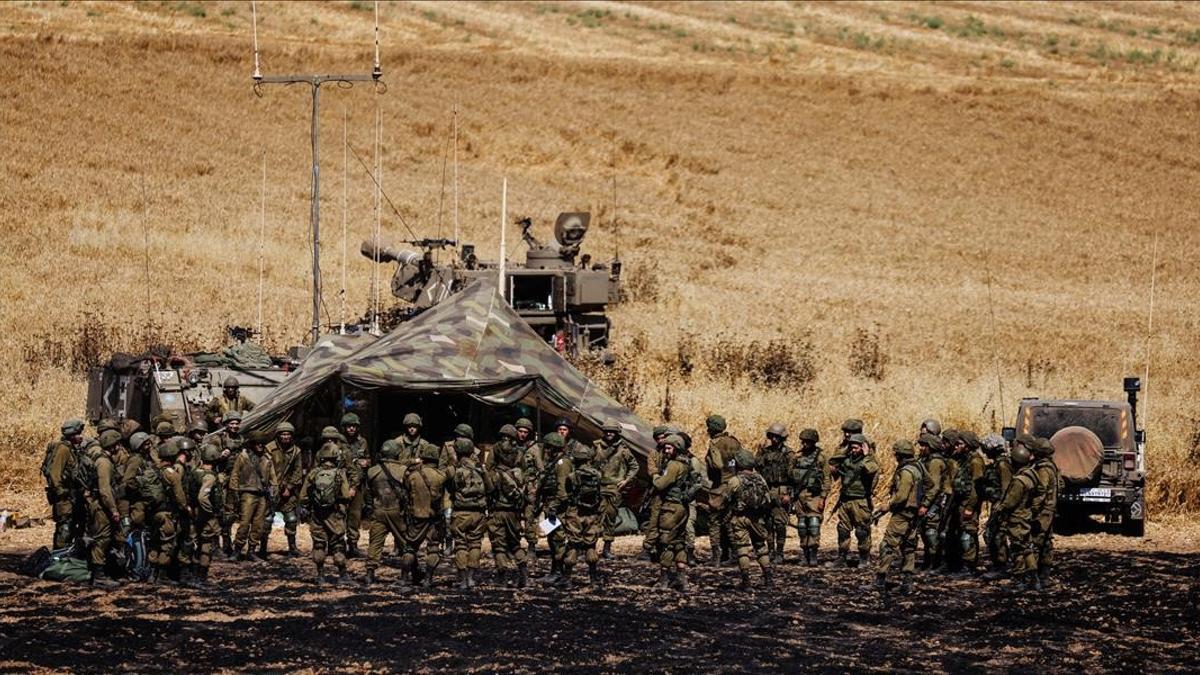 Israeli soldiers of an artillery unit gather near the border between Israel and the Gaza Strip  on its Israeli side May 14  2021  REUTERS Amir Cohen