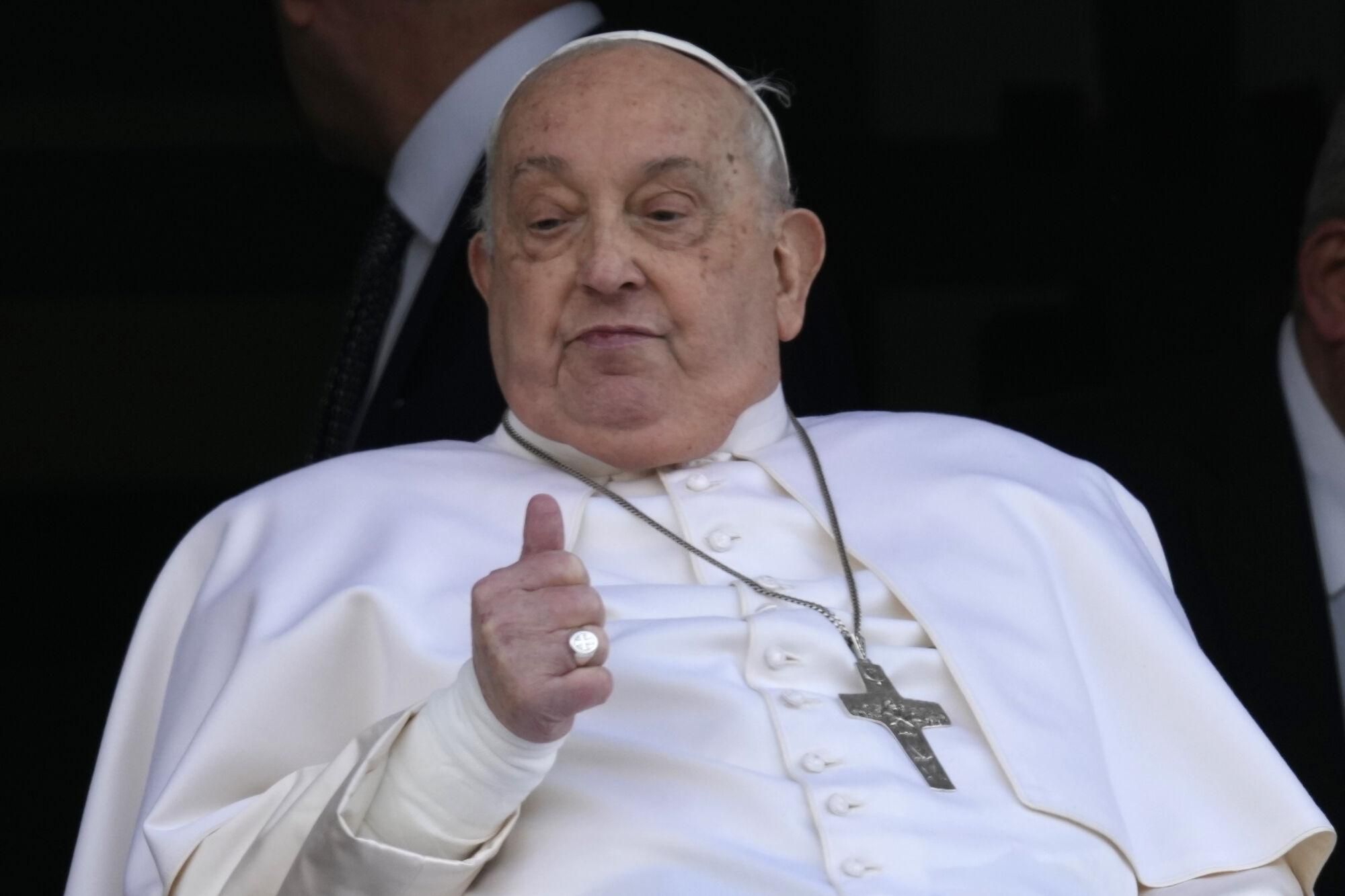 Pope Francis thumbs up as he appears at a window of the Agostino Gemelli Polyclinic in Rome, Sunday, March 23, 2025, where he has been treated for bronchitis and bilateral pneumonia since Feb. 14. (AP Photo/Domenico Stinellis). EDITORIAL USE ONLY/ONLY ITALY AND SPAIN