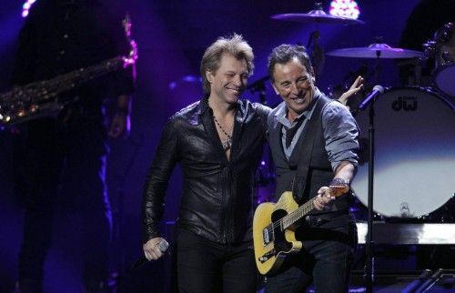 Jon Bon Jovi joins Bruce Springsteen on stage during the "12-12-12" benefit concert for victims of Superstorm Sandy at Madison Square Garden in New York