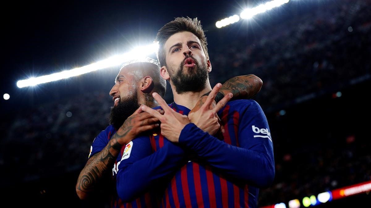 Piqué, abrazado por Arturo Vidal, celebra su gol ante el Rayo.