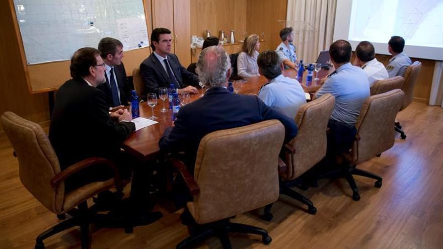 Fotografía facilitada por Presidencia de Gobierno, de la reunión que el presidente del Gobierno, Mariano Rajoy (i), ha mantenido hoy, en la base de Gando, con el el presidente de Canarias, Fernando Clavijo (de frente-2i), el ministro de Defensa, Pedro Morenés (de espaldas-i) y el ministro de Industria, Energía y Turismo, José Manuel Soria, para seguir la evolución de las labores de recuperación de los cuerpos de los tres militares fallecidos al caer al mar el helicóptero en el que viajaban.