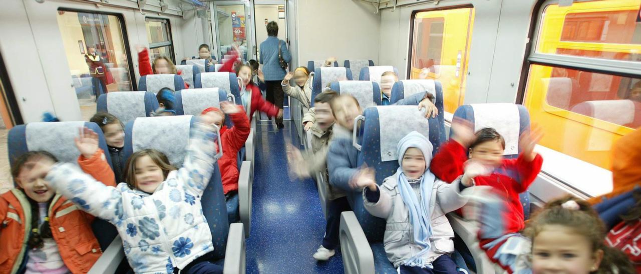 Niños y niñas disfrutando de una excursión en tren.