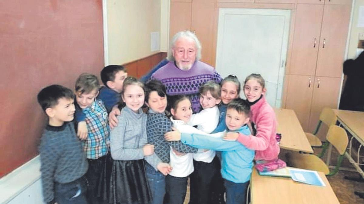 Mariano García, junto a niños ucranianos a los que entregó material escolar.