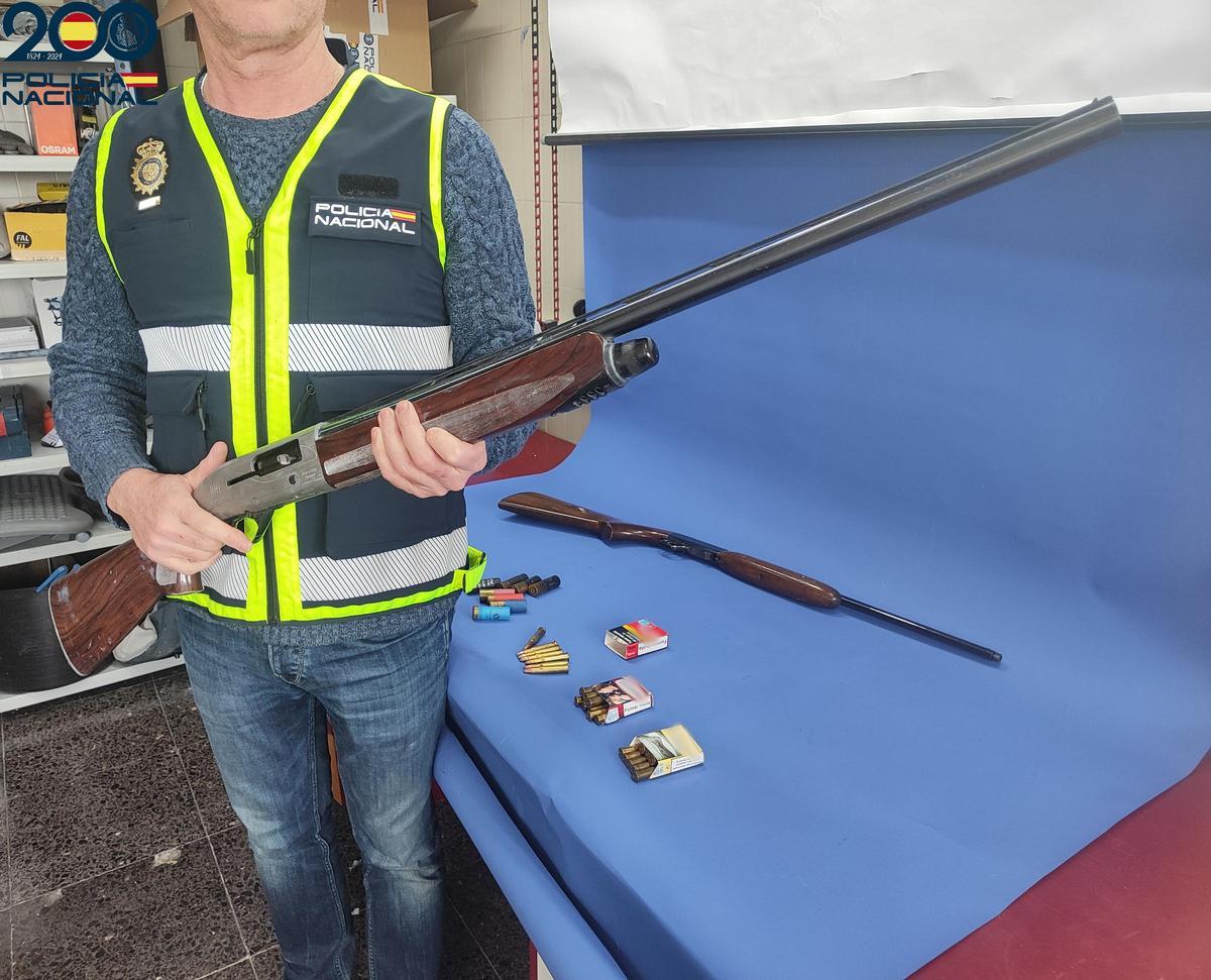 Un policía sostiene una de las escopetas intervenidas.