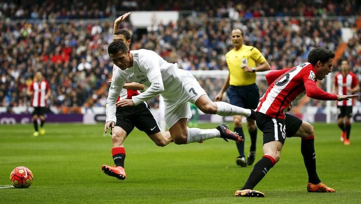 Real Madrid's Cristiano Ronaldo falls to the ground
