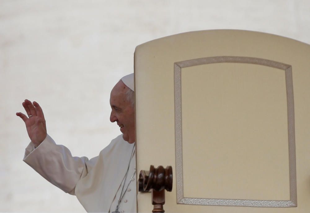 Pope Francis waves as he arrives to lead the ...