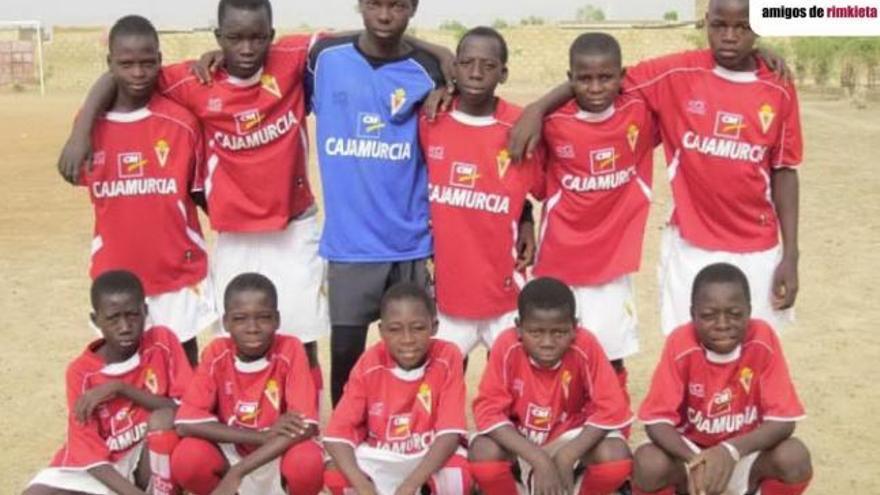 Uno de los grupos de las escuelas deportivas de Burkina Faso posan como si de un equipo de las bases del Murcia se tratara con sus equipaciones.