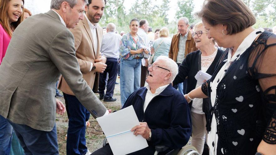 Rueda, ayer, con una de las personas que recibió el título de propiedad. |  FDV