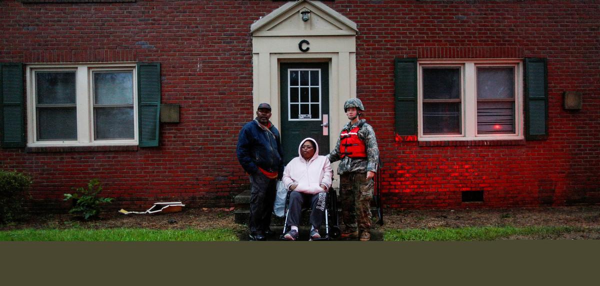 A woman in a wheelchair and attached to a respiratory system is rescued by members of the U.S. Army during the passing of Hurricane Florence in the town of New Berg, North Carolina, U.S., September 14, 2018. REUTERS/Eduardo Munoz