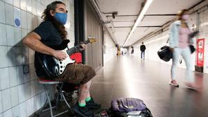 El músico Félix Egea, actuando en el túnel de la estación de metro de Clot que conecta con la estación de Renfe. 