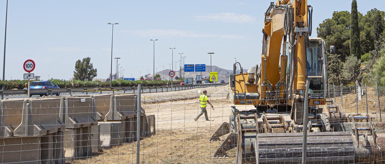 Un técnico pasa por la zona donde se va ampliar el acceso a la rotonda.